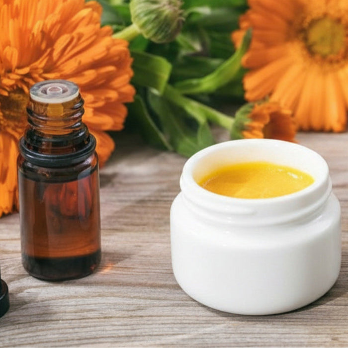 SpeedyVite Deep Heat herbal ointment jar with calendula flowers and essential oil bottle on wooden surface