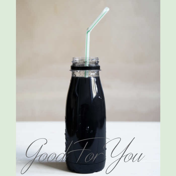 Prepared black detox drink in bottle — mix and sip right away